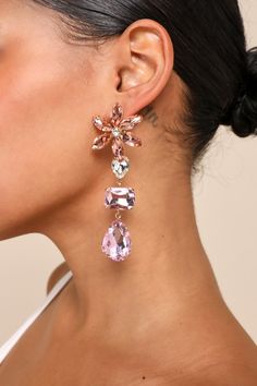 Celebrate all things sweet and sparkly with the Lulus Glittering Blooms Pink Multi Rhinestone Flower Drop Earrings! These darling earrings are composed of shiny, gold-toned metal that supports a variety of sparkling pink-toned rhinestones. Posts boast sweet floral arrangements of stones and support drop-style chains of multicolored rhinestones that finish with teardrop-shaped pendants. Post backs. 3. 75" Long And 1. 55" Wide. 50% Brass, 50% Glass. Imported. Lulus | Glittering Blooms Pink Multi R Party Flower Crystal Earrings, Crystal Flower Earrings For Party, Rose Gold Single Crystal Earring For Party, Glamorous Flower Shaped Party Earrings, Sparkling Flower Earrings For Party, Rose Gold Crystal Earrings With Sparkling Stones For Party, Glamorous Dangle Flower Earrings For Party, Glamorous Flower Earrings For Party, Glamorous Party Dangle Flower Earrings