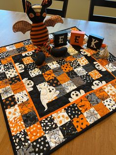 a halloween themed table runner with black and orange accents