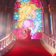 the stairs lead up to an elaborate stained glass window in a building with red carpet