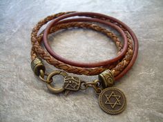 This double strand, double wrap, leather Star Of David charm bracelet will serve as a reminder of your faith. For size reference the charm is 14 mm in diameter. This would also make a great set of His and Her Leather Bracelets. Materials: Lead and Nickel Free - Aged Bronze Toned Alloy Metal Components, Fine Imported double strands of 3mm smooth and 5 mm premium braided leather cord. The secure lobster clasp makes for a quick on and off. Each piece comes with a brand hang tag and a black drawstri Spiritual Brown Wrap Bracelet For Friendship, Leather Bracelets Women, Womens Bracelet, Aged Bronze, Bracelet Leather, Mens Leather Bracelet, Leather Bracelets, Unique Jewelry Designs, Leather Wrap Bracelet