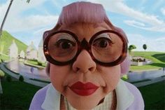 an old woman with glasses and pink hair