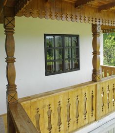 a porch with wooden railings and windows