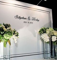 three vases filled with flowers sitting on top of a white tablecloth covered wall