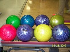 there are many different colored balls in the row on the table, and one is empty