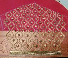 a pink and gold sari with intricate designs on it