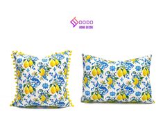 two pillows with lemons and blue flowers on them, one has yellow pom poms