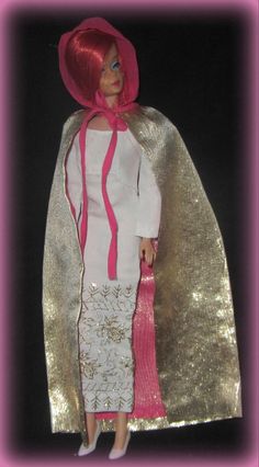 a barbie doll wearing a white dress and pink hat with a red scarf around her neck