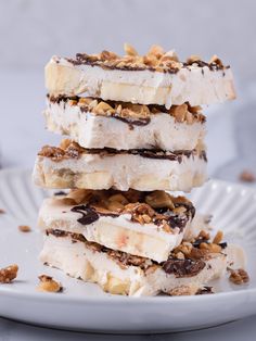 three ice cream bars stacked on top of each other with walnuts and pecans