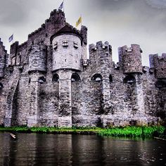 an old castle sitting on top of a lake