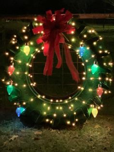 a wreath decorated with christmas lights in the dark