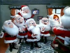 there are many animated santas in the living room and one is pointing at something