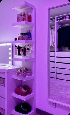 a closet with purple lighting and shoes on the shelves in front of a large mirror