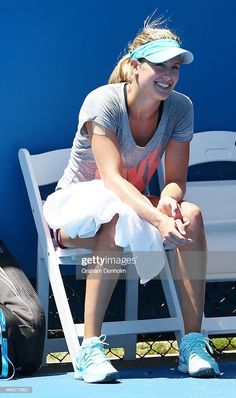 a female tennis player sitting on a bench