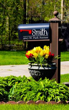 a mailbox with tulips and other flowers in it