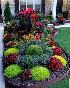 a flower garden in front of a house