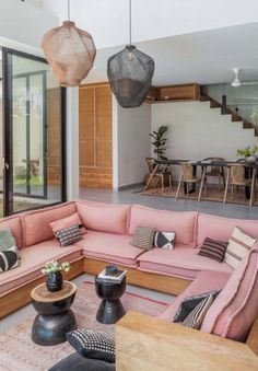 a living room filled with furniture and lots of windows