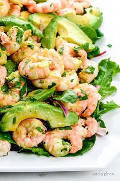 shrimp salad with avocado and cilantro on a white platter, ready to be eaten