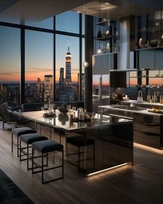 a large kitchen with an island in front of a window overlooking the city at night