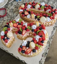 the number six made out of fruit is sitting on top of a marble countertop