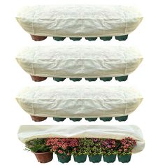 three pots with plants in them sitting on top of each other and covered by a white tarp