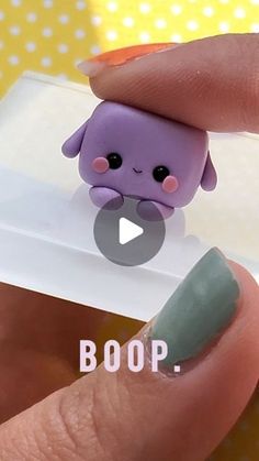 someone is holding a tiny purple toy in their hand with the caption boop