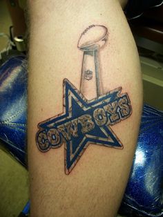 a tattoo on the leg of a person with a football helmet and star in it