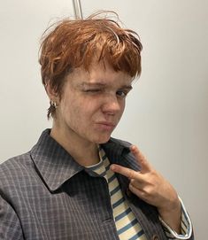 a man with freckled hair is brushing his teeth