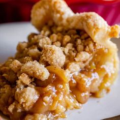 a close up of a piece of pie on a plate with crumb toppings