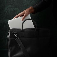 Get not one, but two large interior compartments with the Montreal double zip bag for men. One side has a protective padded laptop pocket, while the other has compartments for other stuff like books, papers, pens, etc. Encloses with strong YKK zippers. The exterior has a large pocket, two padded handles, and an adjustable, detachable shoulder strap. Made with durable buffalo leather that improves with wear and tear. A Danish design by the Lucleon brand. Modern Bags With Laptop Sleeve For Workplace, Classic Workplace Bag With Laptop Sleeve, Modern Laptop Sleeve Bag For Workplace, Modern Workplace Bag With Laptop Sleeve, Modern Workplace Bags With Luggage Sleeve, Black Professional Laptop Bag With Sleeve, Workplace Laptop Satchel Bag, Modern Rectangular Laptop Bag For Workplace, Modern Rectangular Laptop Bag For The Workplace