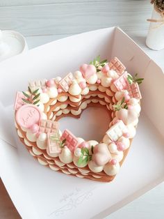 a cake in the shape of a letter decorated with pink and white icing