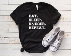 Eat Sleep Soccer Repeat - Unisex Short Sleeve T-Shirt Perfect For A Soccer Fan! We use Bella + Canvas 3001 premium t-shirts which have a soft and light feel, It's very comfy and with it's unisex sizing it's perfect for both men and women. BRAND & MATERIAL: Bella + Canvas - Unisex Short Sleeve Jersey Tee - 3001 - 4.2 oz., 100% airlume combed and ringspun cotton, 32 singles - Athletic Heather and Black Heather are 90/10 airlume combed and ringspun cotton/polyester - Ash is 99/1 airlume combed Basketball Fan Shirts, Theatre Shirts, Slayer Shirt, Dog Mama Shirt, Firefly Serenity, Stargate Atlantis, Nathan Fillion, Joss Whedon, Uss Enterprise