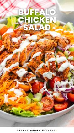 a salad with chicken, lettuce, tomatoes and dressing on it in a white bowl