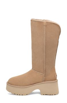 A tall shaft lined with genuine shearling folds down to double the styling options of a boot that's made of soft suede and kicked up on a lightweight foam sole. The foot is lined with cushy, warm UGGplush, a moisture-wicking textile made from a wool-rich blend but crafted to feel and wear like genuine shearling. 3 3/4" heel; 2 1/2" platform (size 11) 13" shaft; 17" calf circumference Pull-on style Leather and genuine shearling upper/wool-blend lining/synthetic sole Shearling may be sourced from