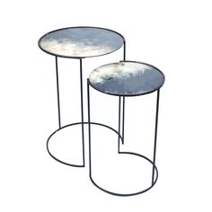 two tables with metal bases on each side and one has a round top, while the other