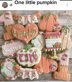 some decorated cookies are sitting on a wooden table with the words love and pumpkins