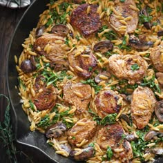 pasta with chicken, mushrooms and spinach in a skillet