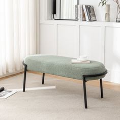 a small bench sitting on top of a carpeted floor in front of a window