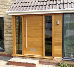 an outside view of a house with wooden doors and windows