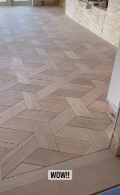 an empty room with wood flooring and tile on the floor, in front of a door