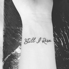 a person with a small tattoo on their arm that says still i rise in cursive writing