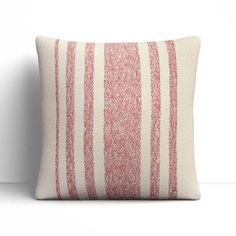 a red and white striped pillow sitting on top of a table