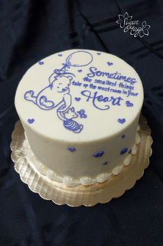 there is a white cake with blue decorations on the top and bottom layer that says something