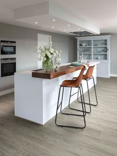 an instagram page with two bar stools in front of a kitchen island and oven