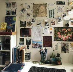 a white desk topped with lots of pictures and books