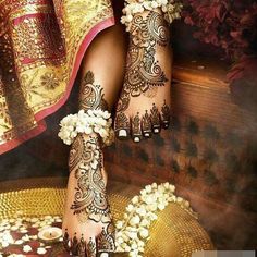 the feet are decorated with henna and flowers