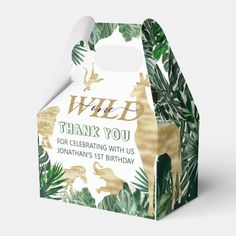 a white and gold giraffe birthday treat box with the words wild thank you for celebrating with us