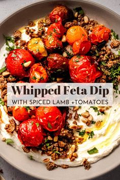 whipped feta dip with spiced lamb and tomatoes in a bowl on a table