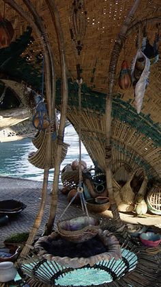 the interior of a hut with baskets and other items hanging from it's ceiling