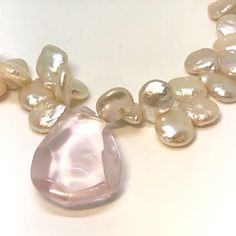 ARTISAN. MASTERFULLY HAND CRAFTED. SIGNED DESIGNER JEWELRY. UNIQUE - ONE OF A KIND. NATURAL QUARTZ GEMSTONES. Gorgeous necklace.lustrous matched creamy freshwater pearls with Central faceted large,Pink, Rose Quartz bead.Sterling gold over silver designer toggle clasp. An exclusive creation by BKF Enterprises for Goddessandco. A lovely, unique Mother's Day Gift! Fully hallmarked and tagged SIZE 18 and 1/4 inches long WEIGHT: 44.31 Total Gram Weight MEASUREMENT: Pearls are 10 x 12 mm in diameter. Handmade Pearl Necklace With Briolette Shape, Handmade Elegant Drop Beaded Necklaces, Handmade Pear-shaped Necklace For Wedding, Handmade Pear-shaped Wedding Necklace, Handmade Drop Pearl Necklace, Elegant Pink Pearl Necklace With Natural Stones, Handmade Drop Necklaces For Wedding, Pearl And Rose Quartz, Weight Measurement