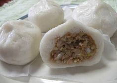 three dumplings are sitting on a white plate